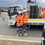 Traffic crew installing lane with bollard truck